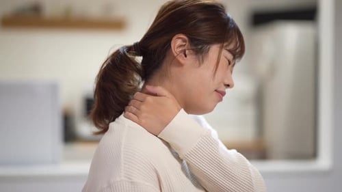 woman suffering from stiff shoulders