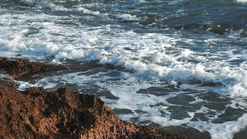 Sea waves crashing on rocks, close up
