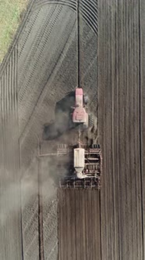 Agriculture Farm Tractor Plow the Earth in the Field View From Height Grain Sowing Vertical Video