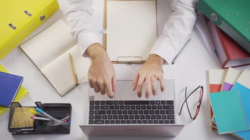 Adult Typing on Laptop in an Office Environment