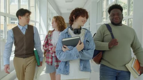 Multi-ethnic Students Walking Along Corridor