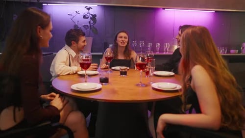 Group of Friends Talking in Night Bar Young Cheerful Girl Emotionally Tells the Story to Friends