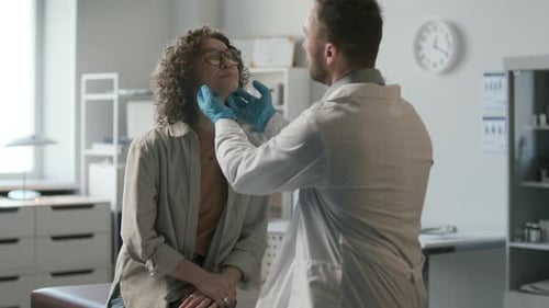 Doctor Examines Woman Patient in Medical Office