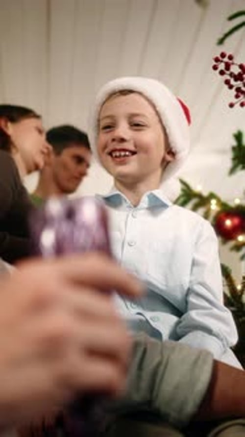 Smiling Boy Wearing Santa Hat Indoors at Christmas