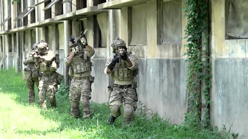 Military army soldiers tactical teamwork in abandoned building.