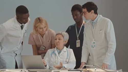 Medical Team Discussing Healthcare on Laptop