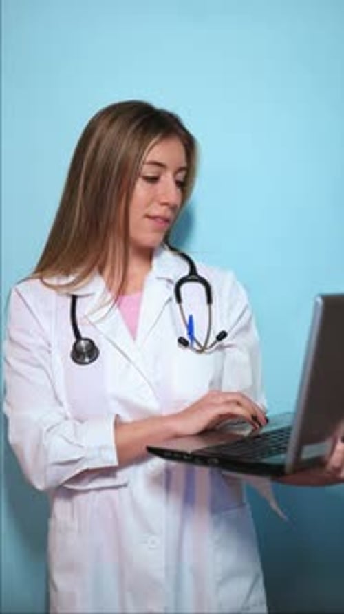 Female Doctor Working on Laptop in Hospital Setting