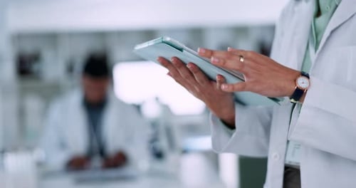 Healthcare Worker Using Tablet in Modern Laboratory