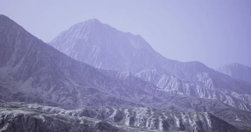 Mountain Landscape with Rugged Terrain and Soft Atmospheric Lighting
