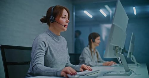 Call Center Female Hotline Operator Talking on Headset with Customer Working on Computer