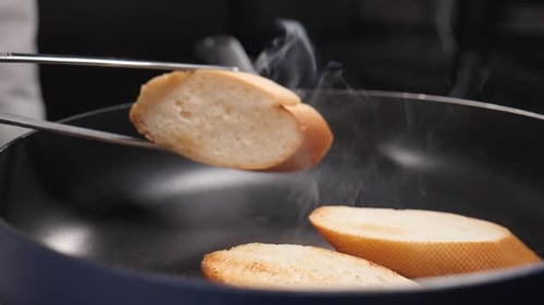 Chef Toasting Bread Slices in Frying Pan