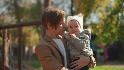 Candid Family Scene with Father and Child Enjoying Sunny Park Tender Moment Captured of Father