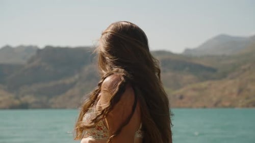 Woman with Flowing Hair Faces the Lake, Gazing at the Majestic Mountains in the Distance, Embracing