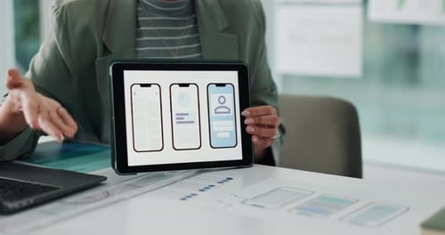 Woman Presenting App Design on Tablet in Office