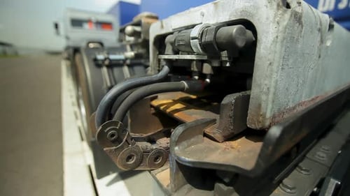 Close-up of hydraulic hoses and parts on industrial equipment