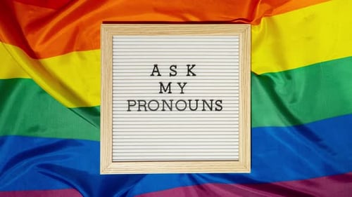 Stop Motion of ASK MY PRONOUNS Text Neo Pronouns Concept on Rainbow Flag Background Gender Pronouns