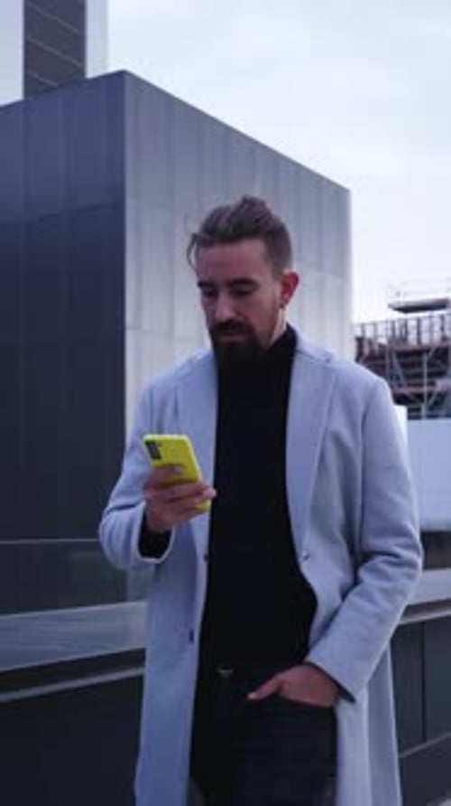 Businessman Walking Outside Financial District Using Phone Sending Text Messages on the Go