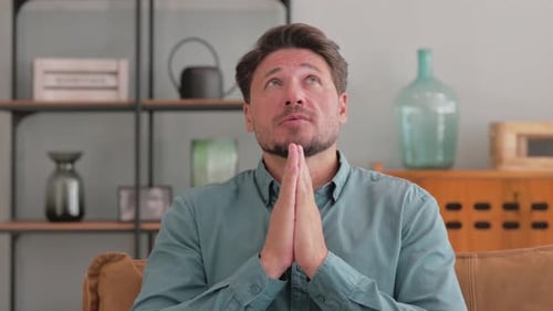 Portrait of Praying Man Asking for Help while Feeling Scared and Worried