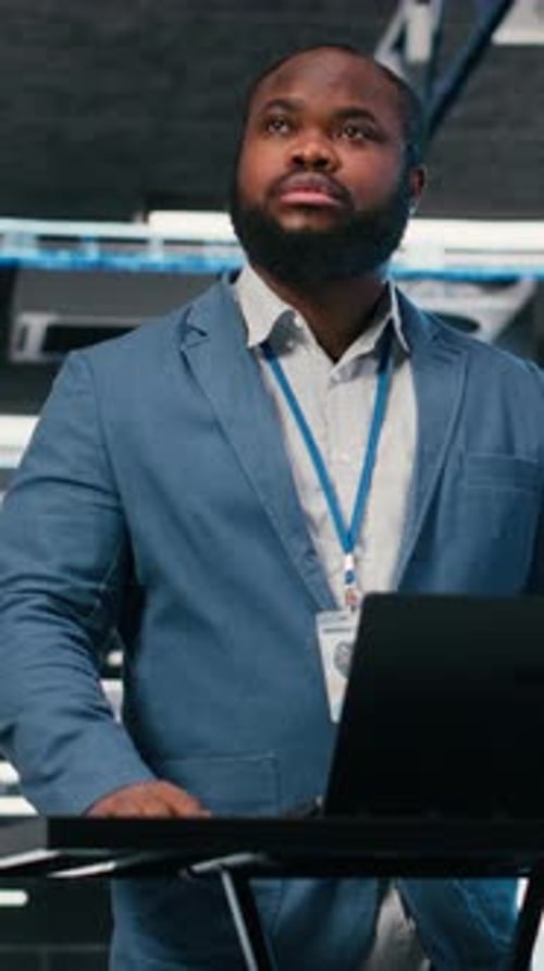 Vertical Video Server Farm Programmer at Workplace Desk Using Laptop to Optimize Electronics