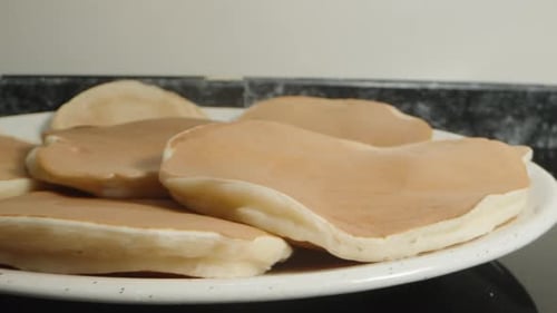 Freshly baked pancakes, they are hot and steam comes from them, close-up.