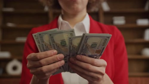 Business Woman Counts Stack of Cash Money