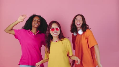 Smiling Young Women Dancing in Colorful Clothes