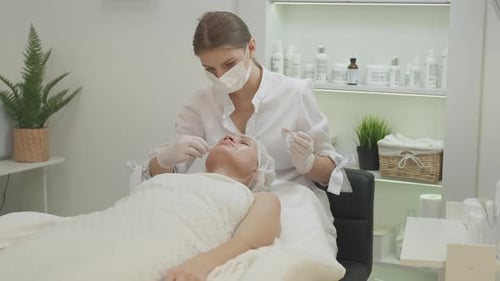 Woman Applies Cream During Medical Procedure