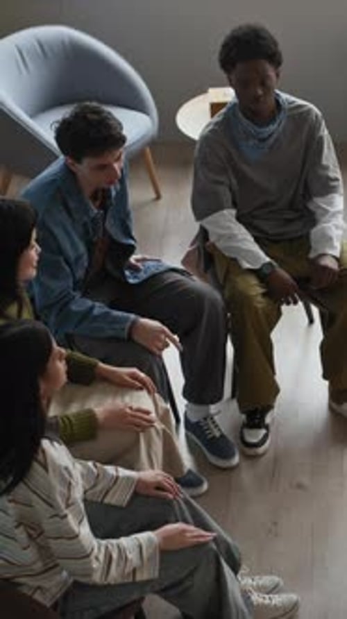 Young Adults in a Circle Putting Hands Together