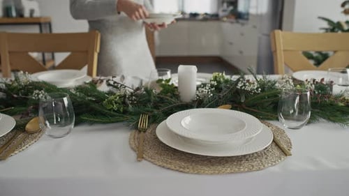 Close up of two people preparing table at home for Christmas Eve. Shot with RED helium camera in 8K.