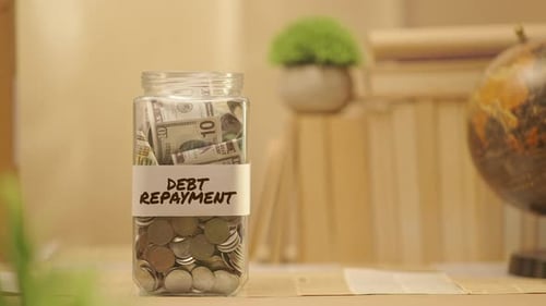 PERSON SAVING MONEY FOR DEBT REPAYMENT