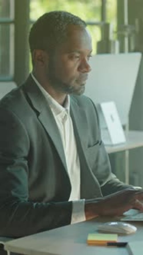 Professional Man Working on Computer in Modern Office