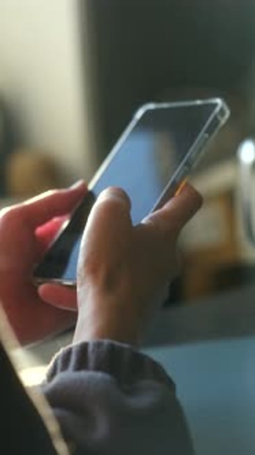 Hands Holding a Smart Phone, Indoors