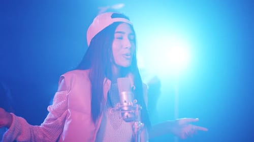 Young Woman Singing and Rapping at a Recording Studio
