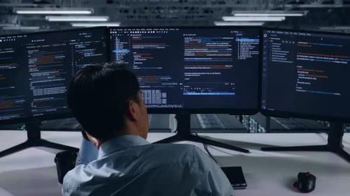 Back View Of Bored Asian Man Developer Write Code In Data Center