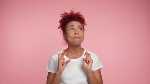 Young Woman Crossing Fingers Hoping For Good Luck