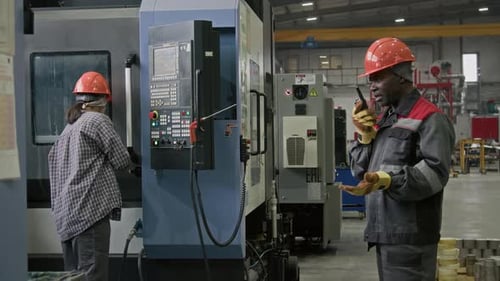 Plant Technician Controlling Production Process Talking on Walkie-Talkie