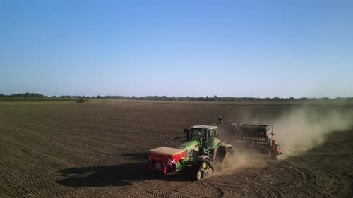 Tractor on the field seeding wheat