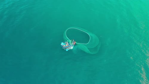 Drone view of the fishing boat is netting anchovies fish on the sea, a traditional fishing boat of V