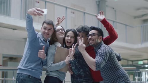 Group of young multi-ethnic students are making selfie photos in an university.