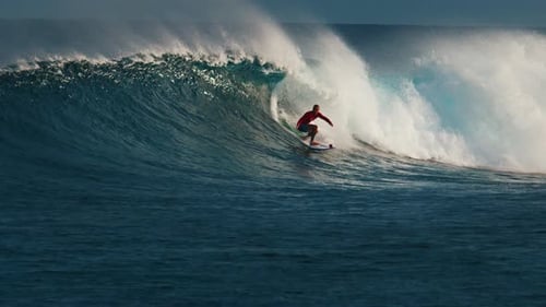 Surfer surfs the wave. Male surfer rides the wave in the Maldives