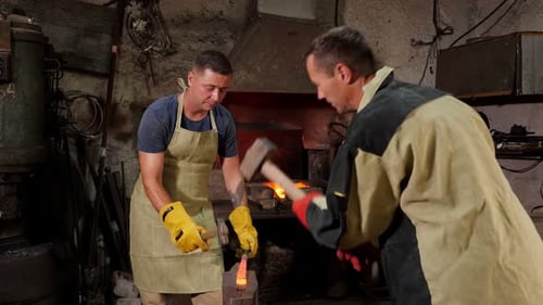 Men Working with Metal in Workshop