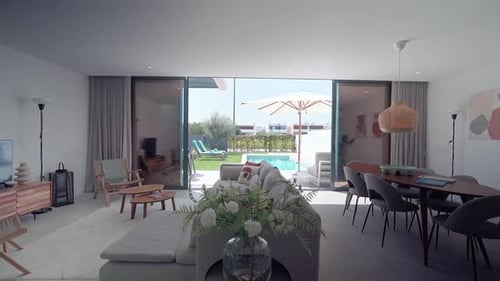 Sunlight Illuminates a Contemporary Living Room Showcasing a Seamless Transition to an Outdoor Oasis