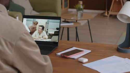 Adult Has Video Call on Laptop While Working