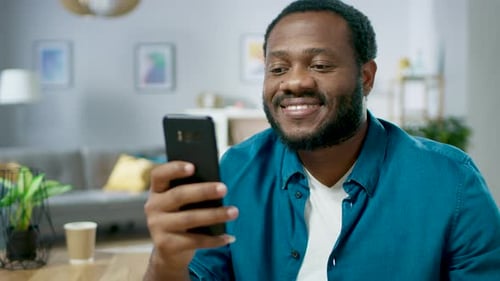 Portrait of the Handsome Young Man Using Smartphone, Browsing in Internet, Checking Social Networks