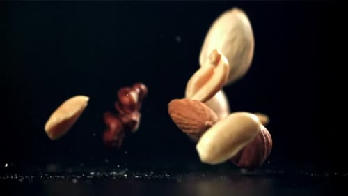 A Variety of Nuts Fall on the Table Filmed on a Highspeed Camera at 1000 Fps