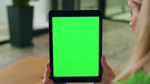 Woman Holds Tablet Device With Green Screen