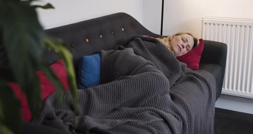 Blonde Haired Woman Sleeping on Gray Couch