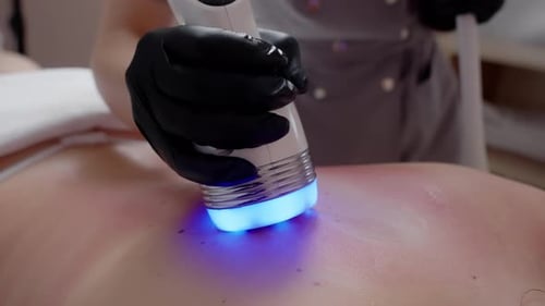 Blue Light Therapy Treatment on Patient's Back
