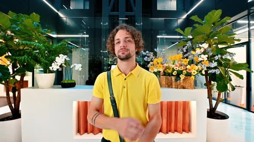 Man in yellow shirt standing in an office building