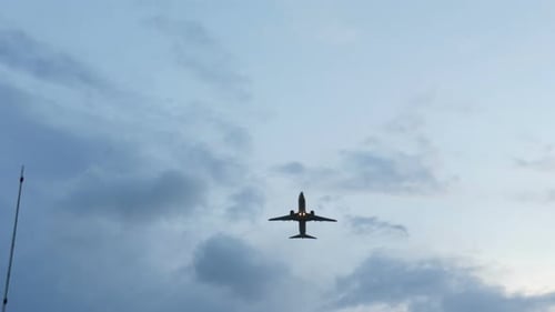 Plane Takes Off From the Airport at Sunset Above